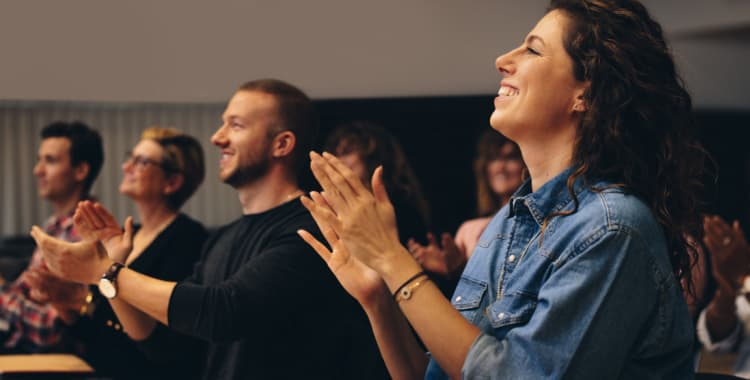 Businesspeople clapping at a convention 